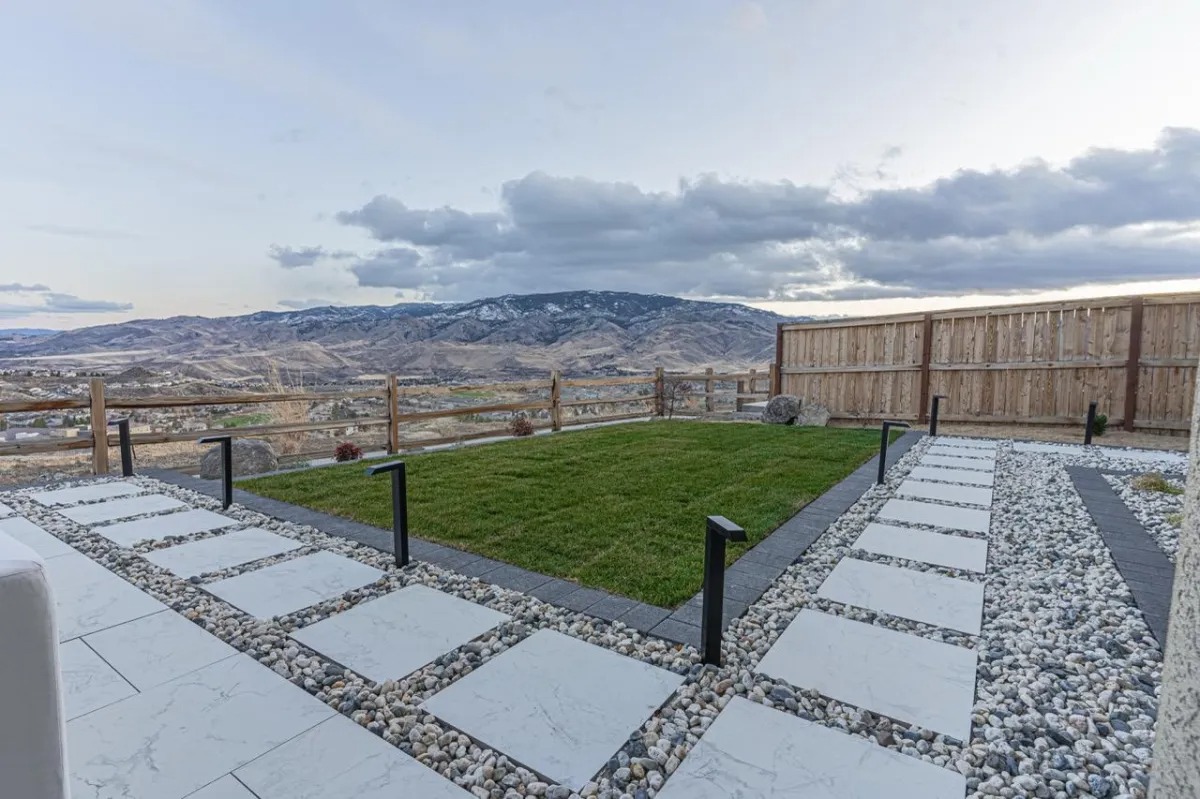 Large-format paver walkway set in rock with turf panel and mountain view